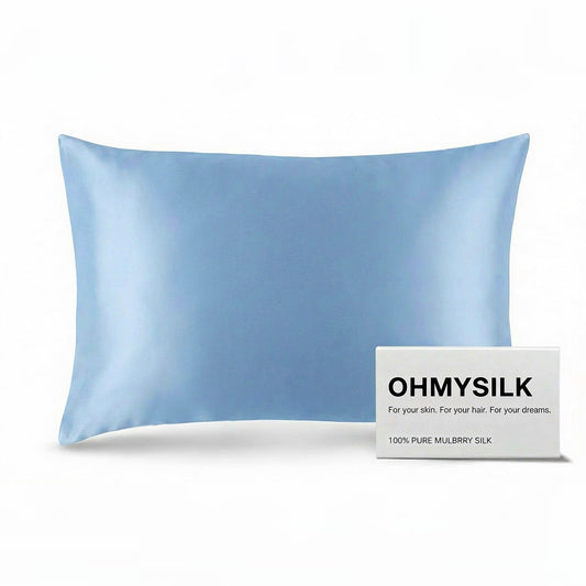 Close-up shot of ohmysilk Silver Blue 22 momme mulberry silk pillowcase with a secure envelope closure, showing natural silk texture and soft wrinkles.
