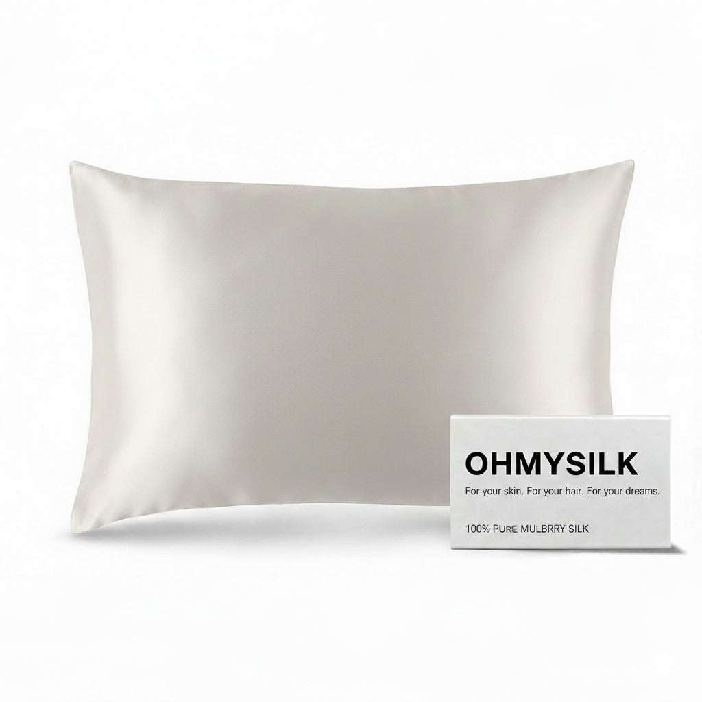 Close-up shot of ohmysilk White 22 momme mulberry silk pillowcase with a secure envelope closure, showing natural silk texture and soft wrinkles.