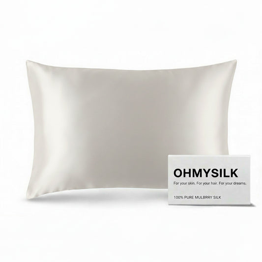 Close-up shot of ohmysilk White 22 momme mulberry silk pillowcase with a secure envelope closure, showing natural silk texture and soft wrinkles.